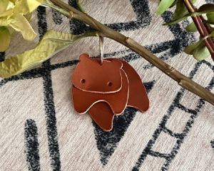 Artistic leather hippo key holder featuring a rustic burnished edge finish.