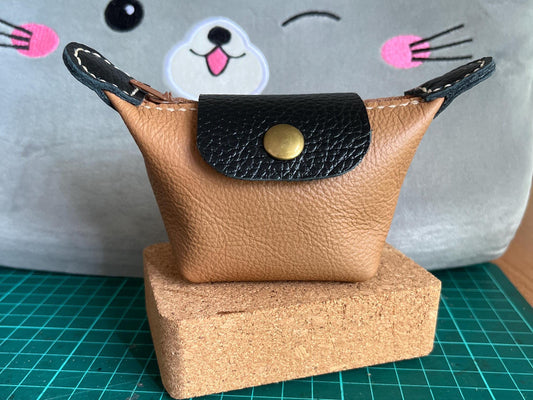 Completed  leather Mini Purse sitting on a cutting mat