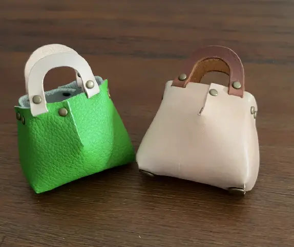 Small no-sew leather bag used as a bag decoration to a backpack.