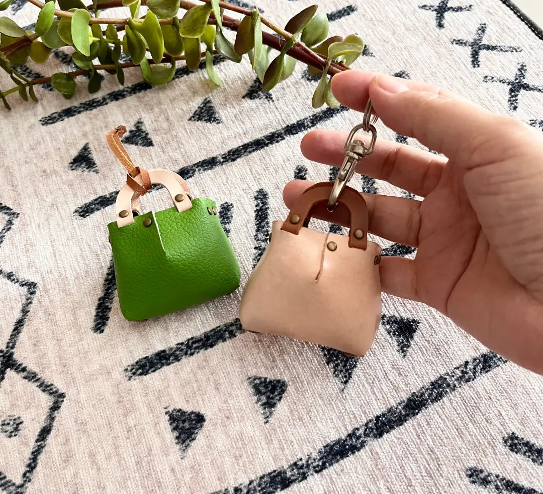 Minimalist leather bag charm template with clean lines and simple fold-over flap.