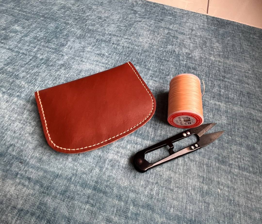 Back view of the handmade leather card case showing clean stitch lines.
