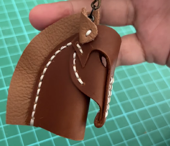 Aesthetic leather horse charm used as a decorative pendant for designer bags.