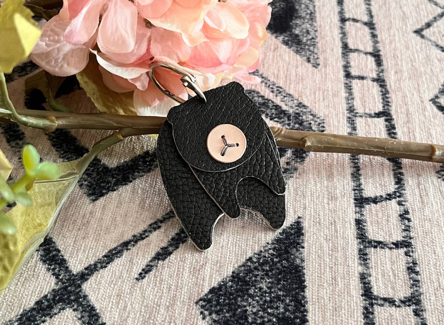 top view of a leather bear keychain in pebble-grain black leather.