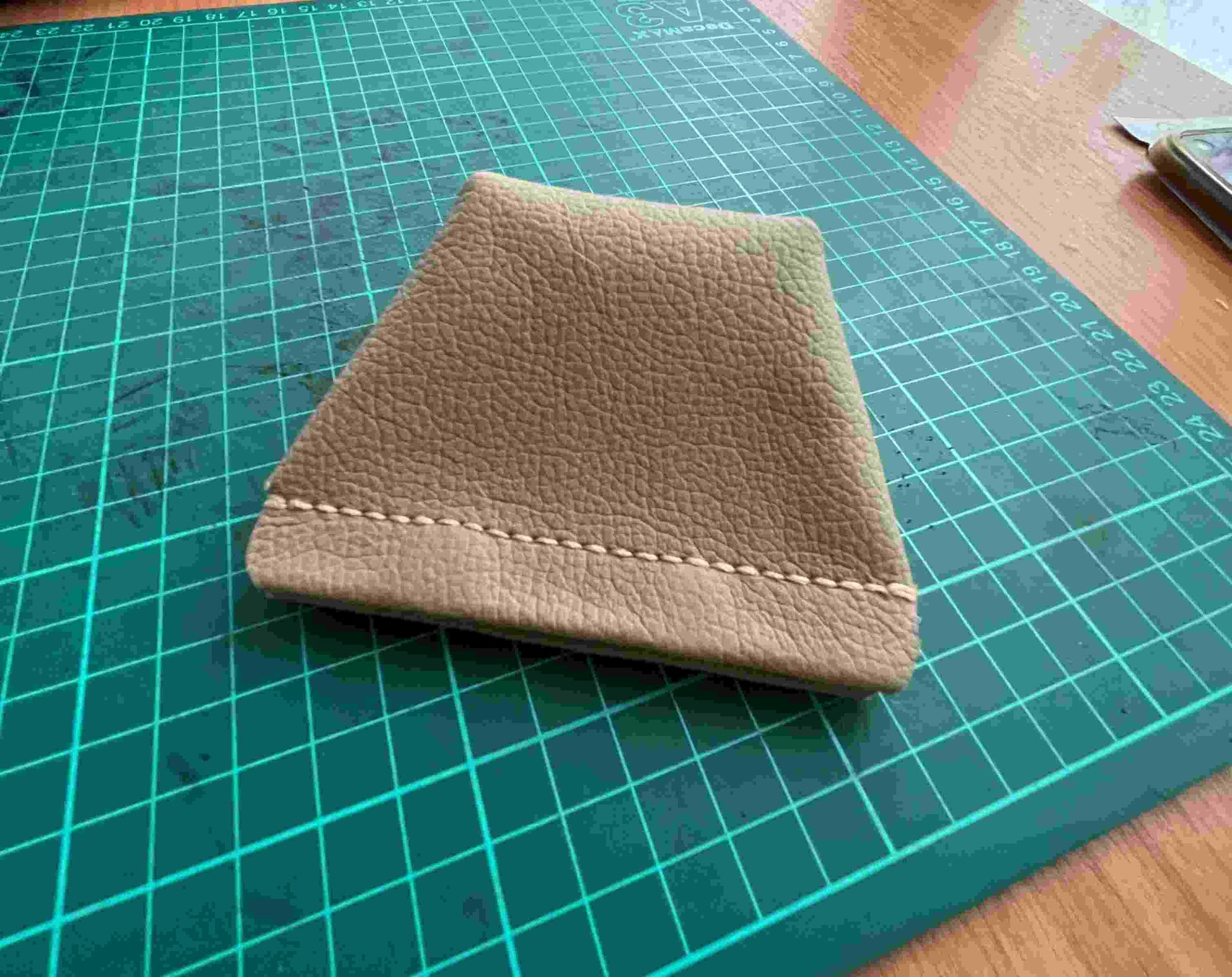 Easy leathercraft project using scraps to make a small coin purse with a button.