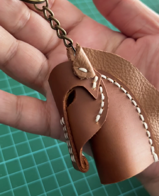 Small DIY leather horse project showcasing intricate hand-stitched details.