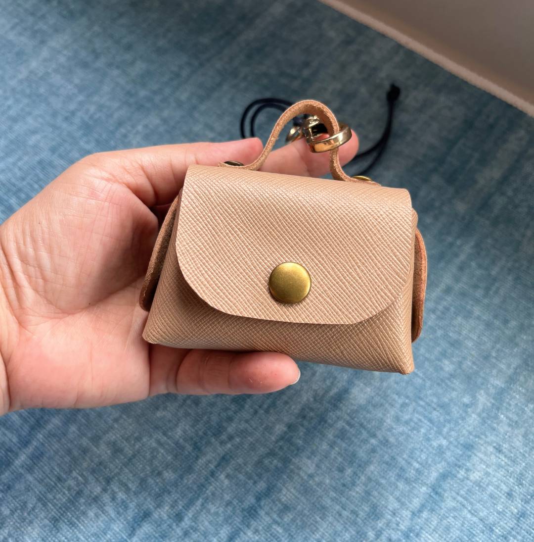 Finished  no-stitch Leather AirPod Pro pouch with handle and metal clasp accessory. 