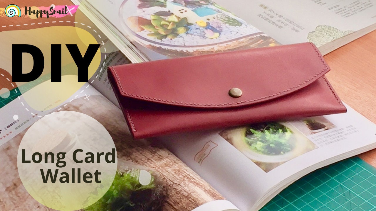 Flat lay of long leather card wallet styled on magazine.