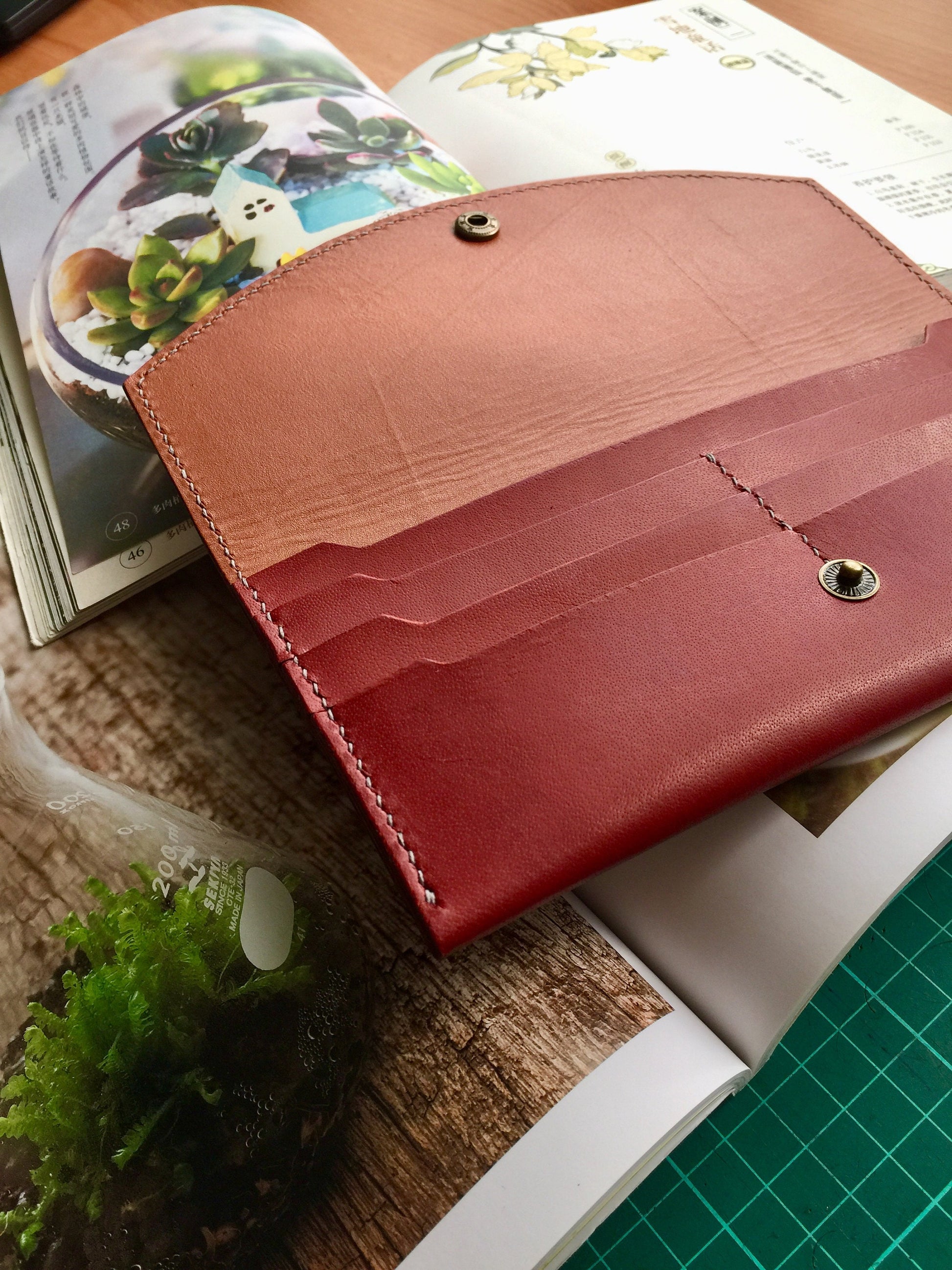 Interior close-up of long leather card wallet with stitching detail