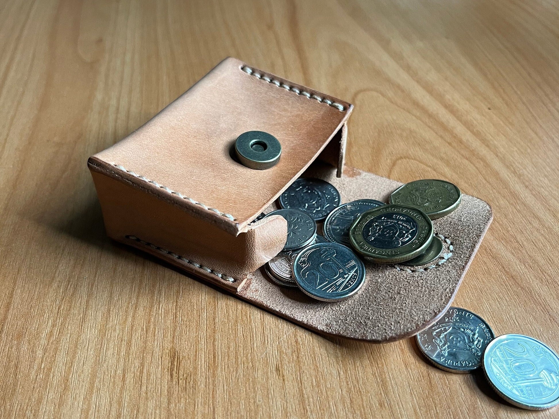 Minimalist leather coin bag pattern showing the clean internal compartment.