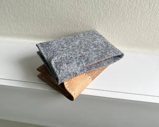 Close-up of snap button hardware placement on leather wallet template.