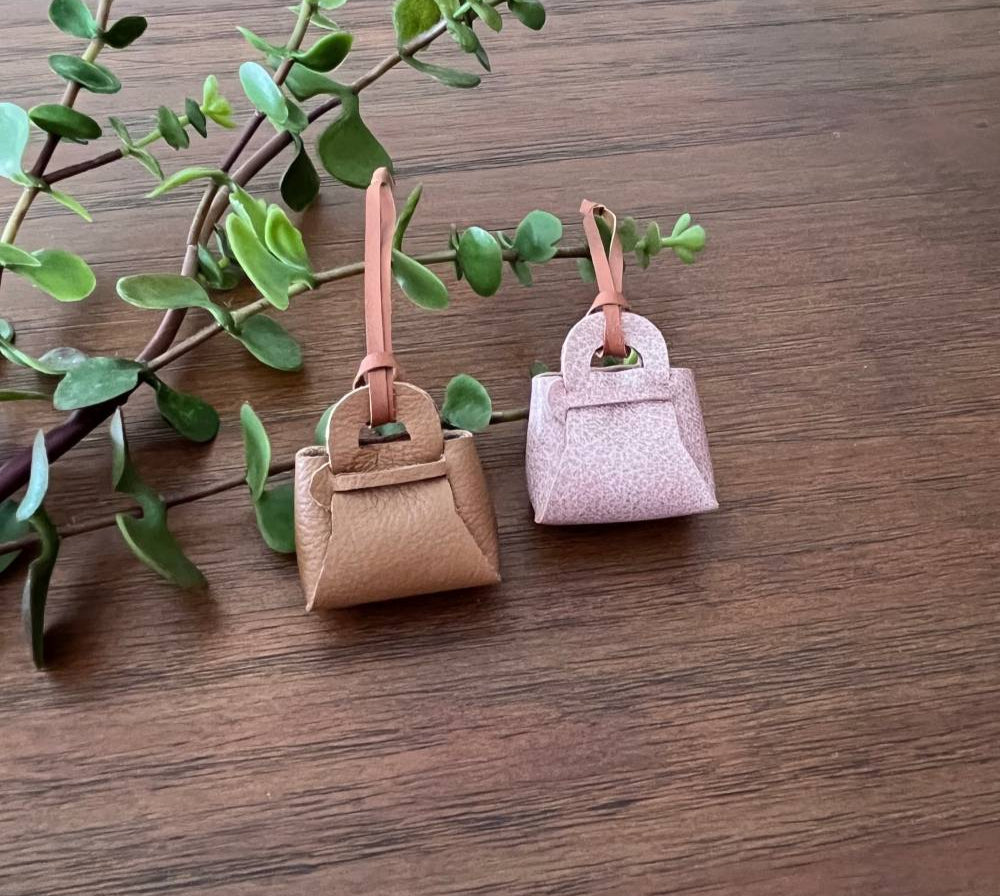 Small no-sew leather bag used as a bag decoration to a backpack.