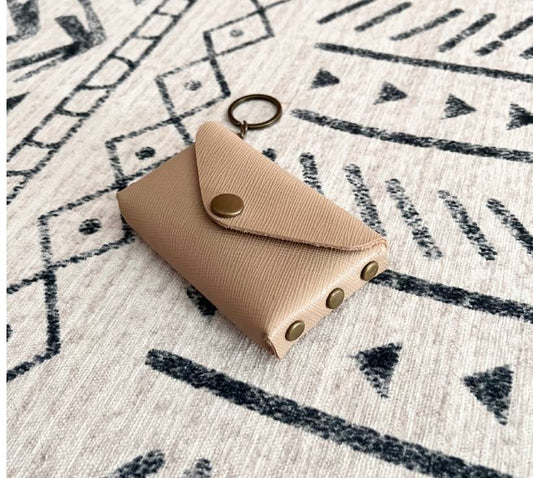 Front view of tan leather no-sew card holder with bronze snap and keyring
