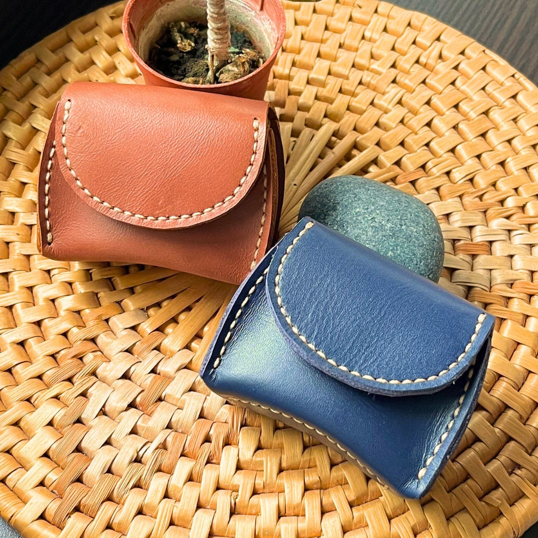 Modern minimalist leather coin purse with seamless edges and a hidden snap.