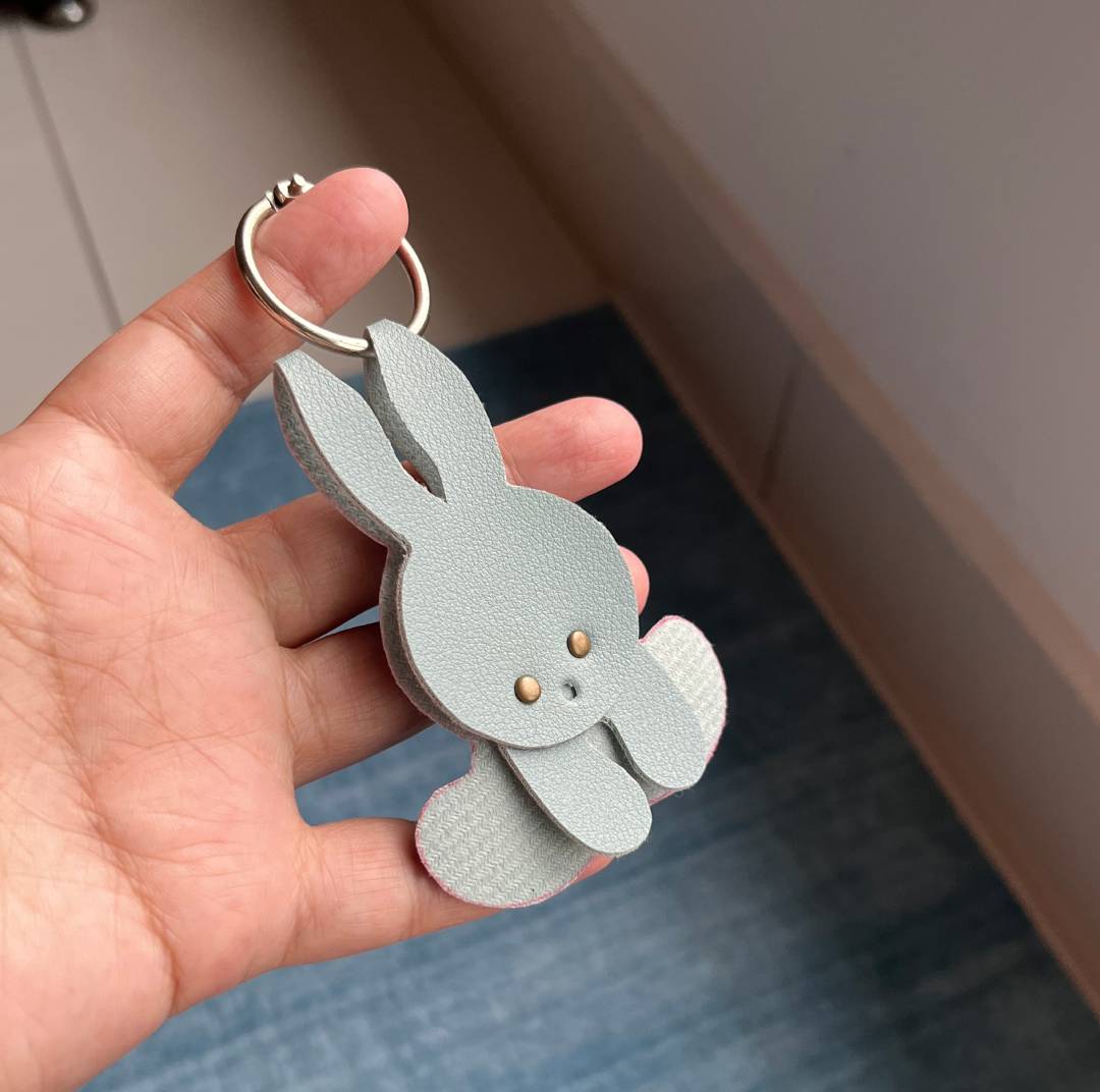 Cute leather bunny keychain bag charm handmade using a PDF and SVG digital pattern template.