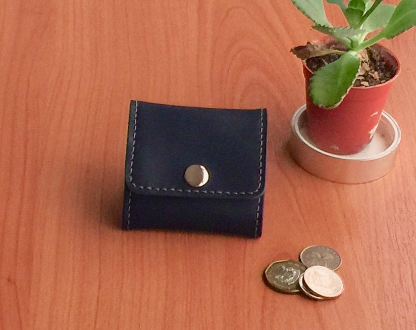 Hand-stitched vegetable tanned leather coin bag with a secure snap closure.
