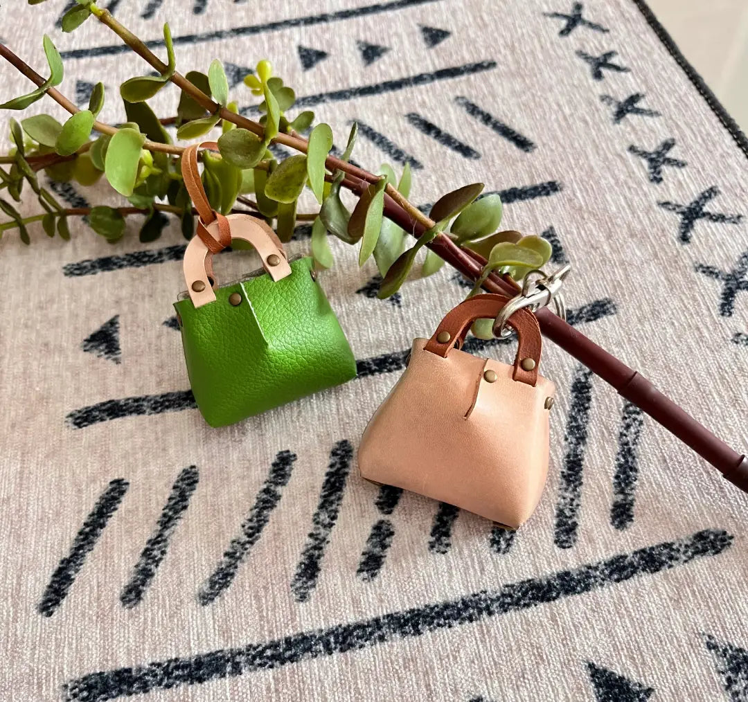 Stylish leather pouch charm with cute  handle.