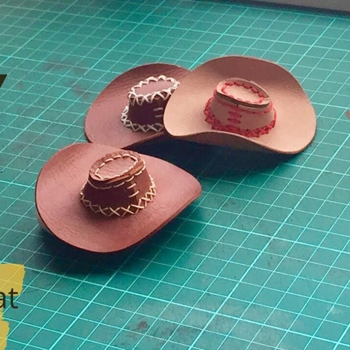 Small leather cowboy hat designed as a photo prop for cats or small dogs. Western style leather doll hat suitable for BJD dolls and collectible miniature figures.