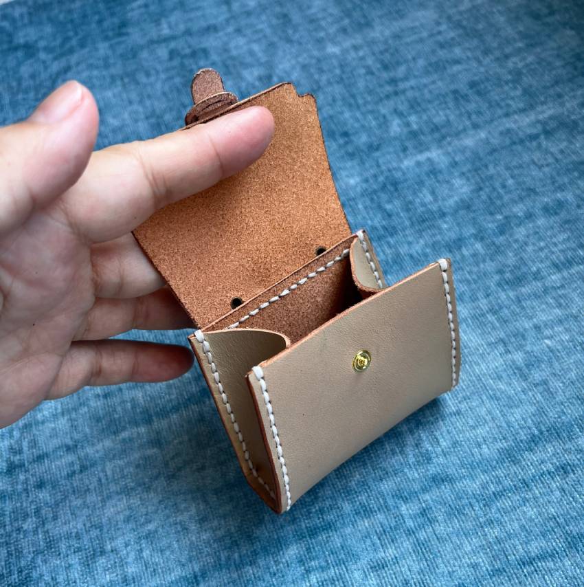 Top view of tiny leather satchel showing the space inside.